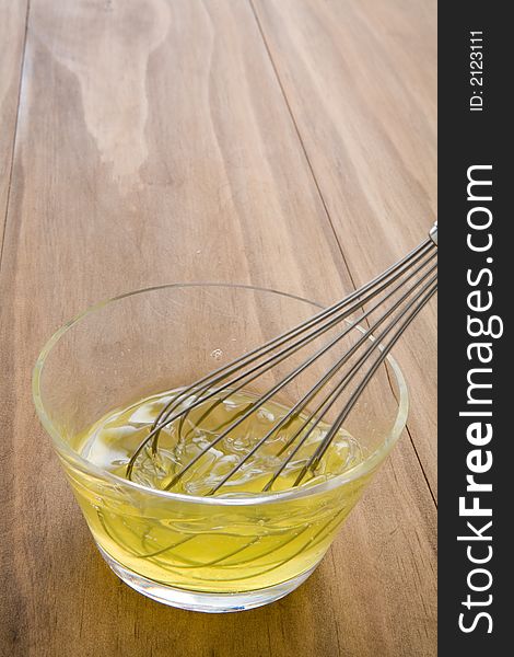 Whisking raw egg whites in a glass bowl