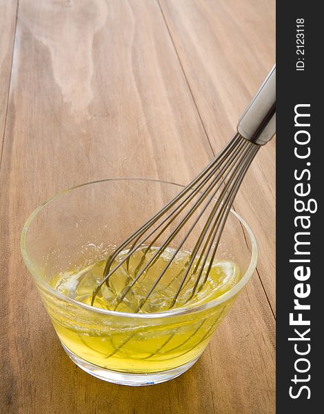 Whisking raw egg whites in a glass bowl