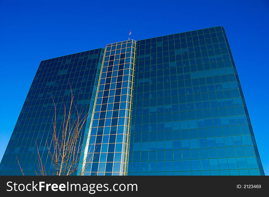Office building of glass on a blue sky. Office building of glass on a blue sky