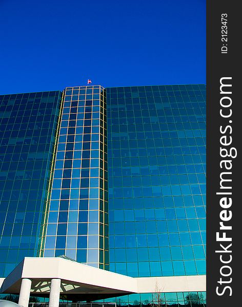 Office building of glass on a blue sky. Office building of glass on a blue sky