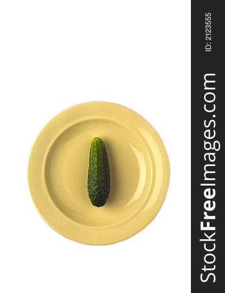 Green cucumber in  yellow plate on white background
