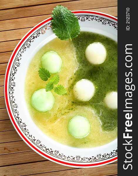 Tasty soup made from melon decorated mint on the plate