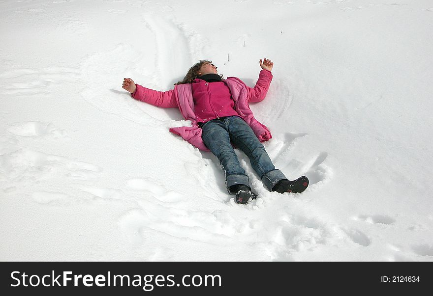 Happy girl playing in snow during winter time. Happy girl playing in snow during winter time