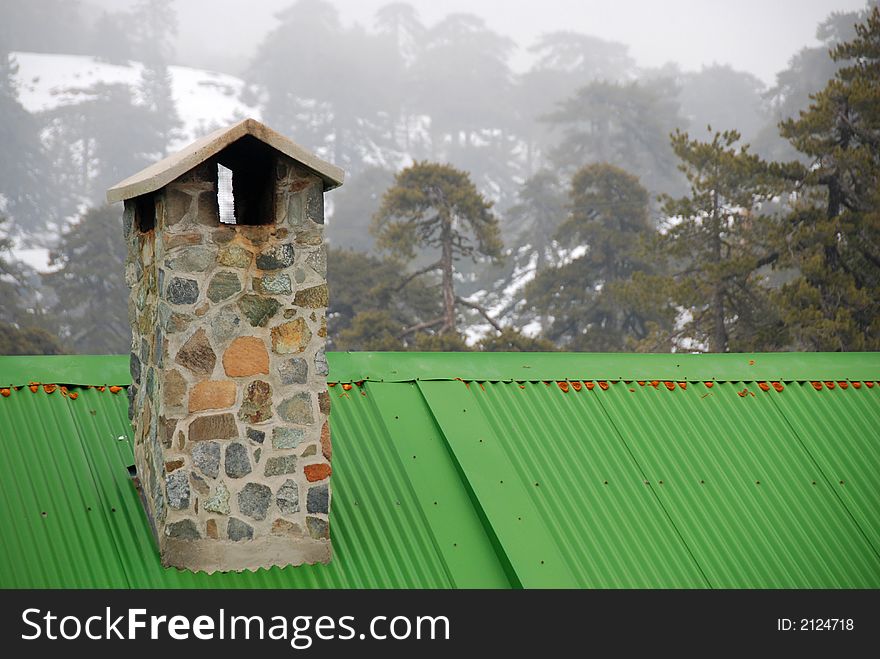 Roof with chimney in snow during winter at Troodos mountains in Cyprus