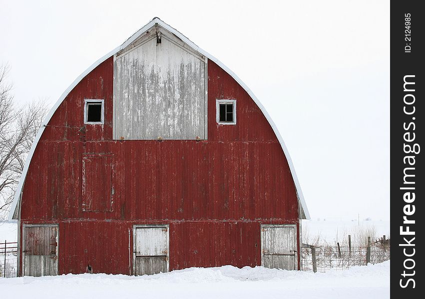 A photo of a red barn  on winter day in Iowa. A photo of a red barn  on winter day in Iowa.