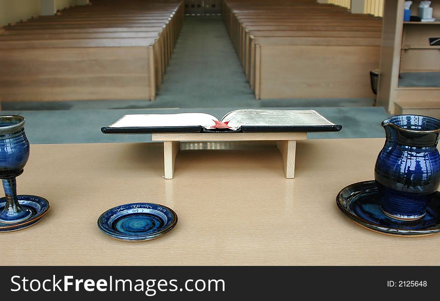 Inside view of a church with the bible open on a table. Inside view of a church with the bible open on a table.