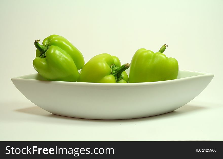 3 green Peppers in lovely Table-ware