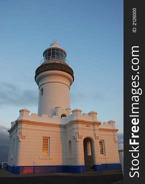 Lighthouse bathed in light from the setting sun at Byron Bay, Australia. Lighthouse bathed in light from the setting sun at Byron Bay, Australia