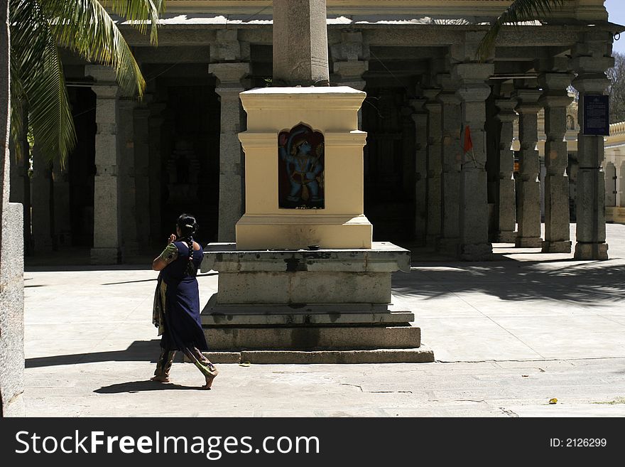 Woman praying at Hindu temple. Woman praying at Hindu temple.