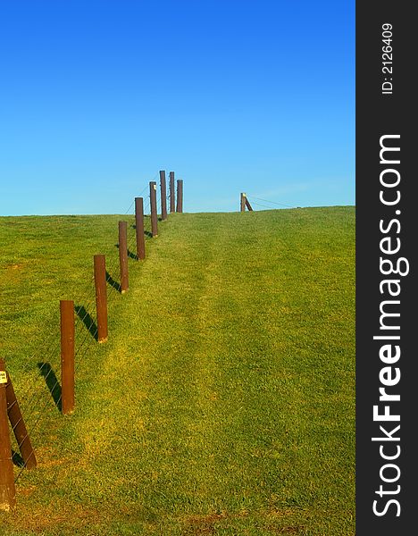 Fence in a park with blue sky back ground