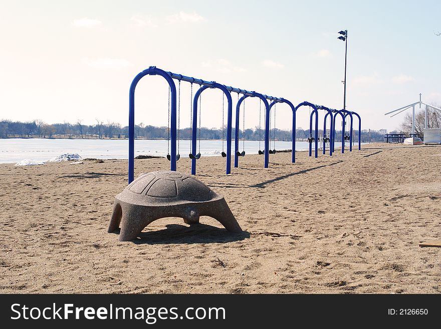 A picture of recreational equipment ready to be played upon by children; but it is still winter. A picture of recreational equipment ready to be played upon by children; but it is still winter.