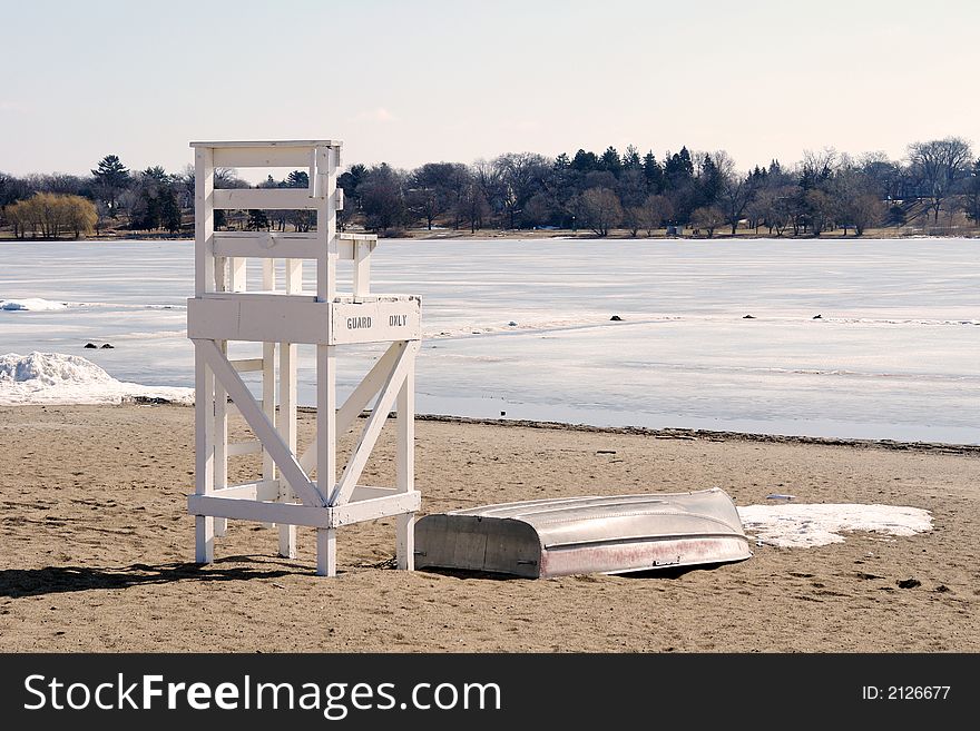 A picture of a life gaurd chair on the beach at the edge of winter. A picture of a life gaurd chair on the beach at the edge of winter.