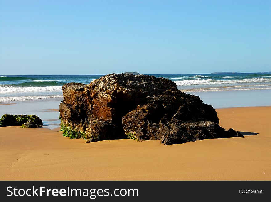 Large rock on an australian beach. Large rock on an australian beach