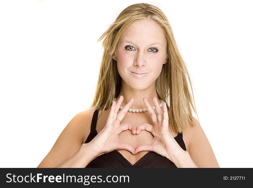 A girl in black dress making a heart symbol with her hands. A girl in black dress making a heart symbol with her hands