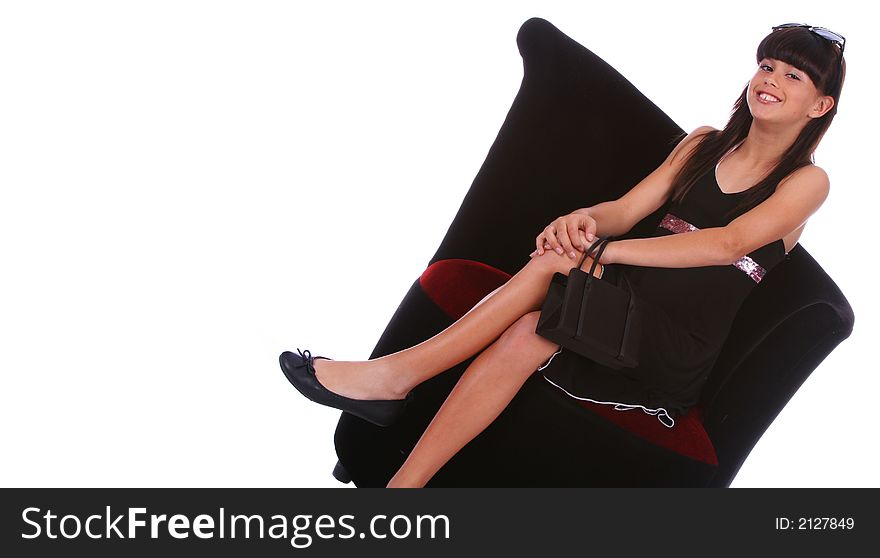 Isolated trendy young girl holding purse and sit on the sofa. Isolated trendy young girl holding purse and sit on the sofa