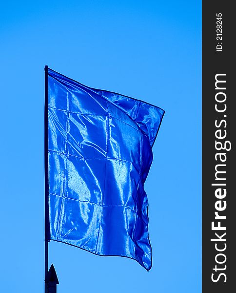 Blue flag waving sky background
