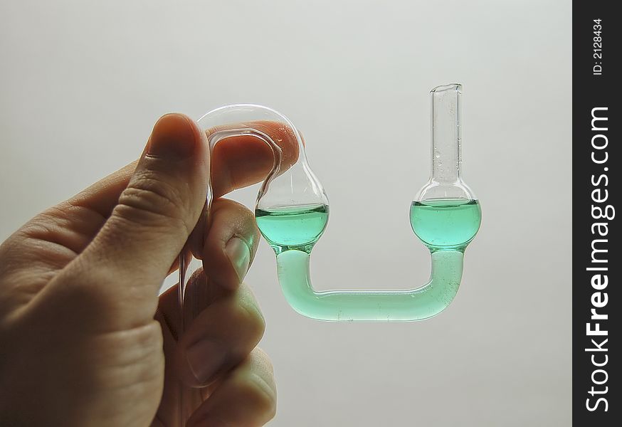 Chemical glass. Tube in the hand