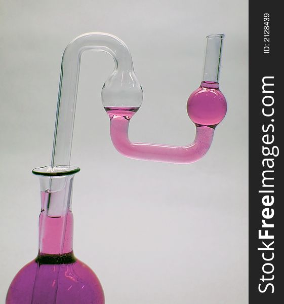 Chemical glass. Tube and flask with pink liquid. Chemical glass. Tube and flask with pink liquid