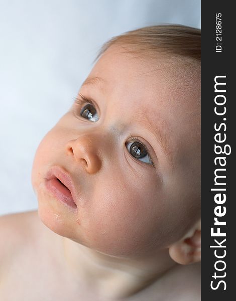 Image of beautiful 11 month old baby sitting in front of a white background. Image of beautiful 11 month old baby sitting in front of a white background