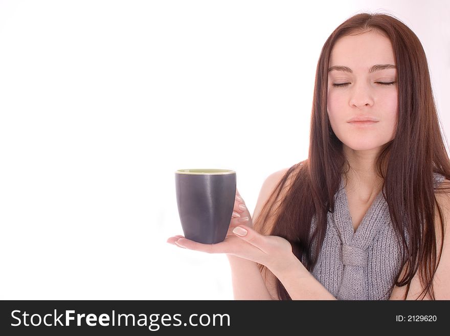 A beautiful woman is holding a cup. A beautiful woman is holding a cup