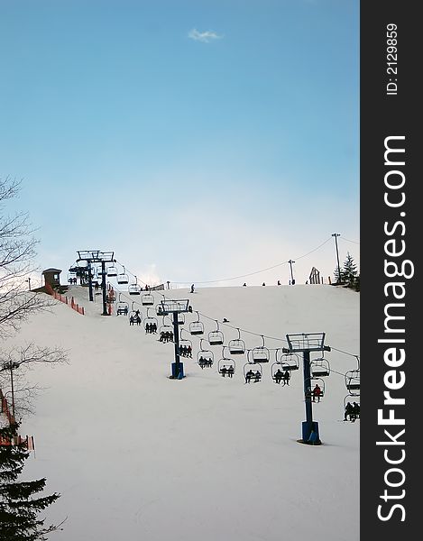 Chairlift at a ski resort to the peak. Chairlift at a ski resort to the peak