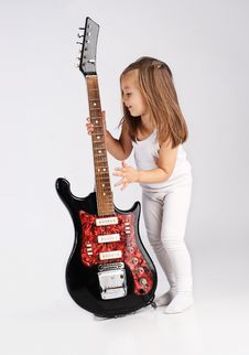 Small Child Hold Red Acoustic Guitar. Music Stock Photos