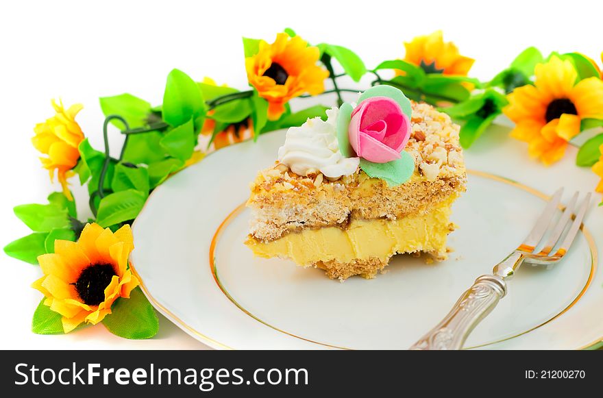 Piece of birthday cake with flowers and roses