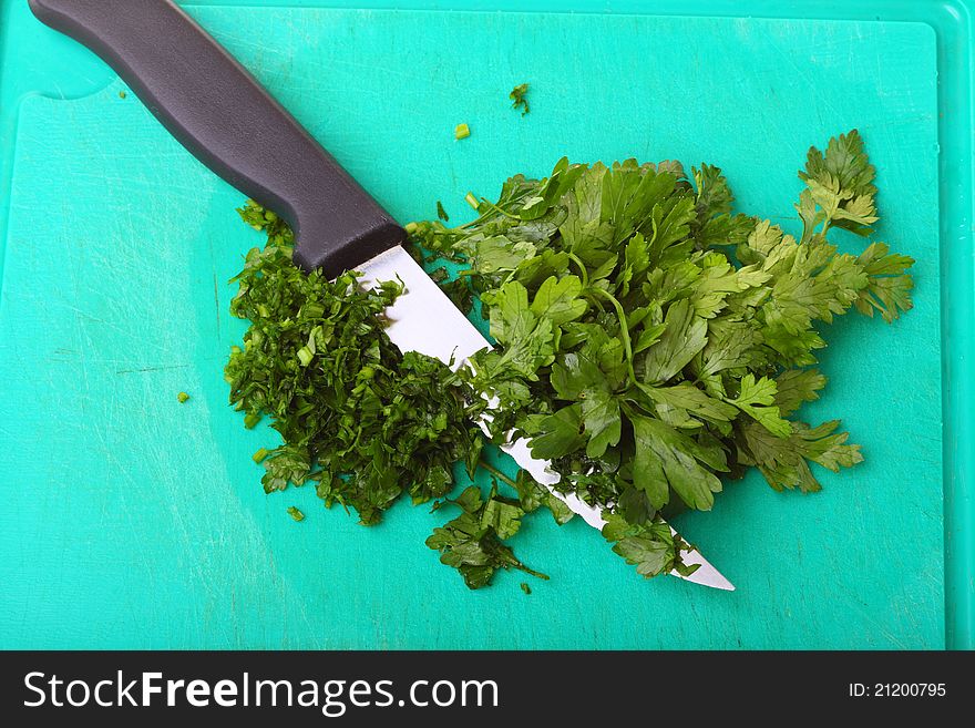Twig of parsley and kitchen knife nature food texture background. Twig of parsley and kitchen knife nature food texture background