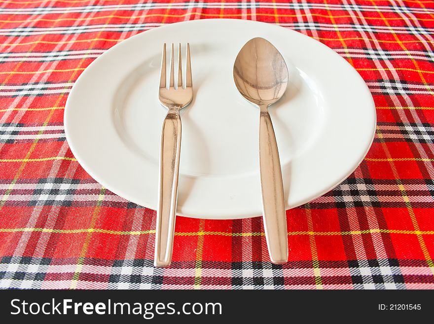 Fork And Spoon On White Dish