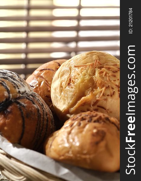 Bread in a basket with morning light. Great images for food and beverages article or any design involving food and drinks. Bread in a basket with morning light. Great images for food and beverages article or any design involving food and drinks.