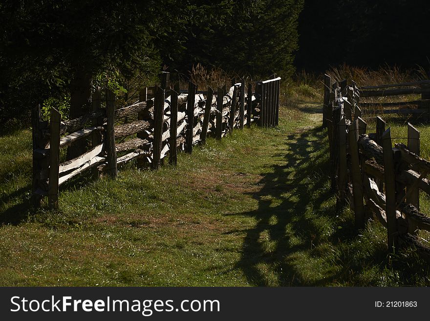 The morning sun bathed wooden fence was built in the traditional way