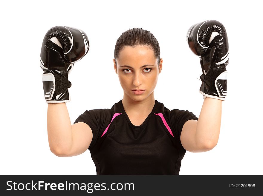 A young female wearing black boxing gloves on an isolated white background. A young female wearing black boxing gloves on an isolated white background