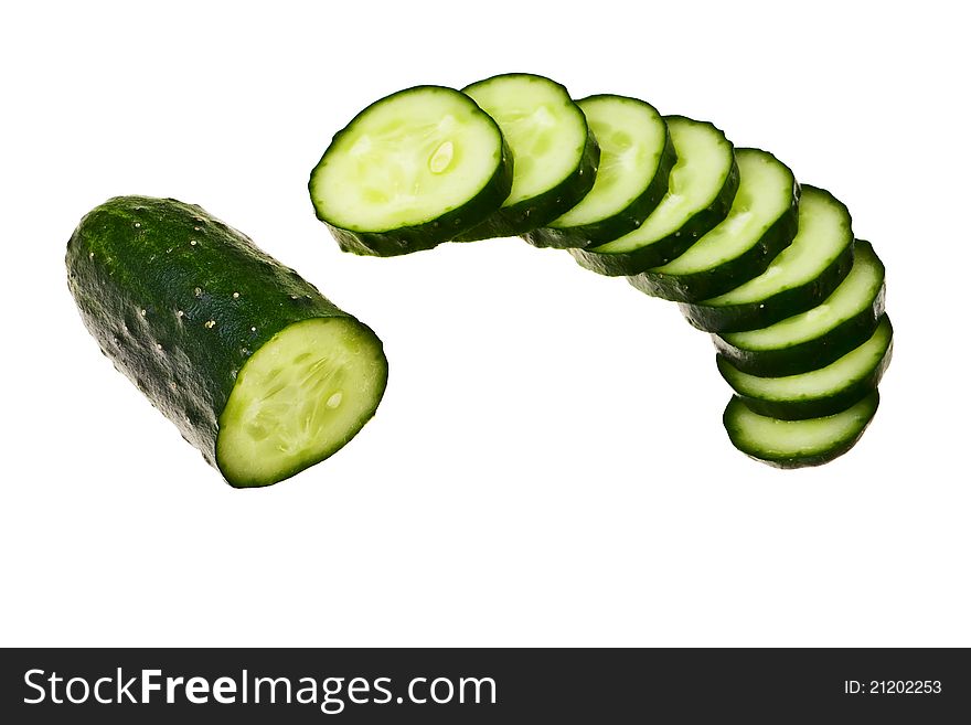 Cucumber half cut and slices isolated over white background. Cucumber half cut and slices isolated over white background.