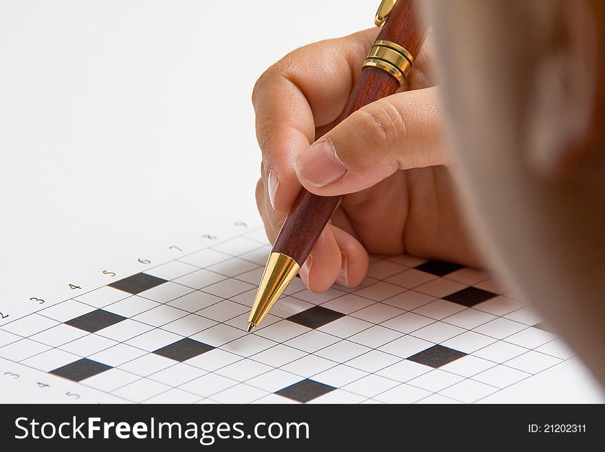 A woman doing a crossword puzzle empty. A woman doing a crossword puzzle empty