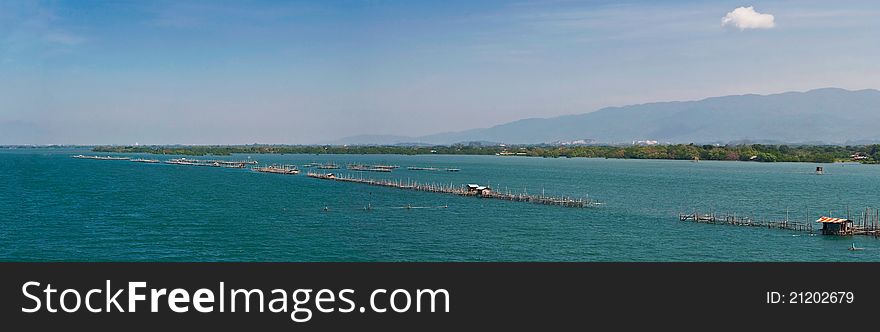 Panorama of wooden pier in blue sea. Panorama of wooden pier in blue sea