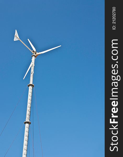 Wind turbine on blue sky background. Wind turbine on blue sky background