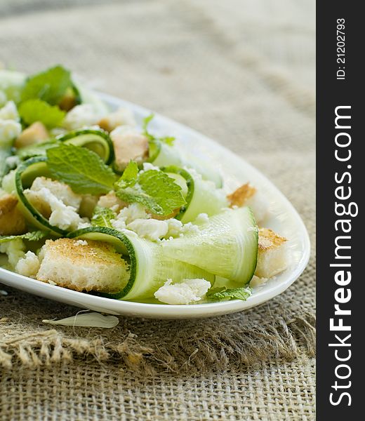 Fresh salad with cucumber and cheese. Selective focus