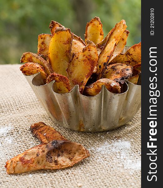 Roasted potatoes with spices in bowl. Selective focus