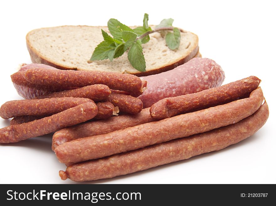 Mead sausages with garlic sausage and bread on white background