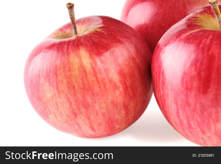 Three ripe red apple on white background
