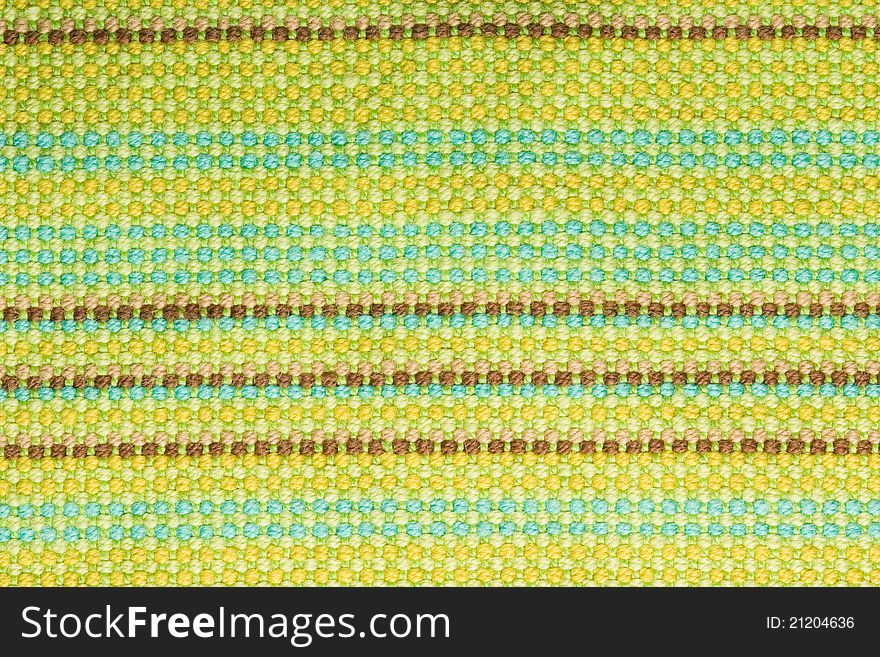 Textile background with colorful green, beige and yellow stripes