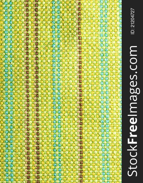 Textile background with colorful green, beige and yellow stripes