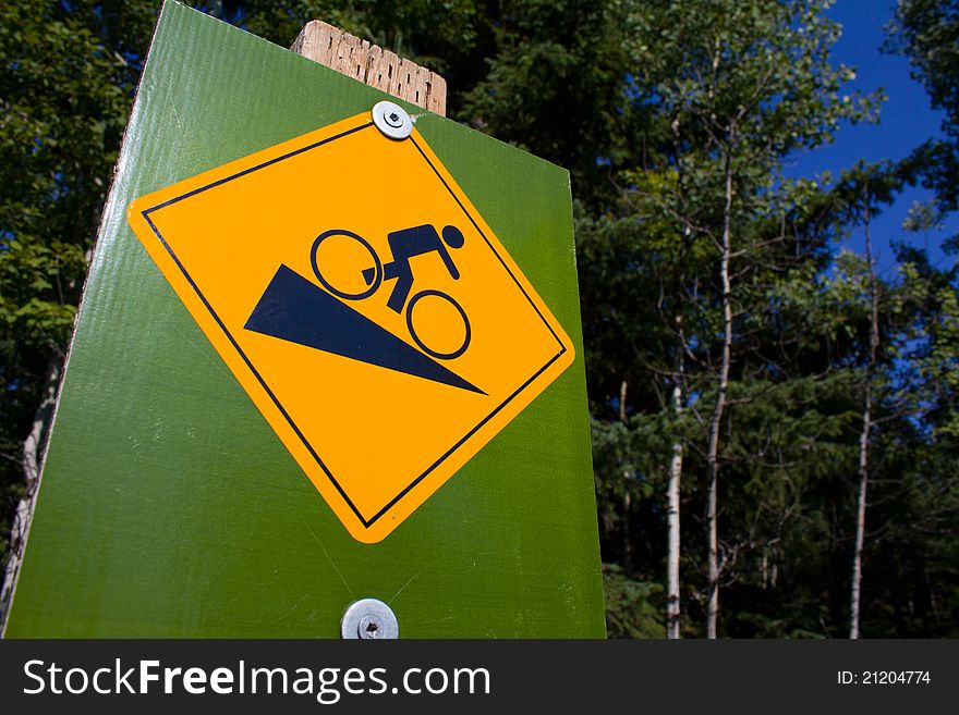 A cycle path sign warning of a steep hill. A cycle path sign warning of a steep hill