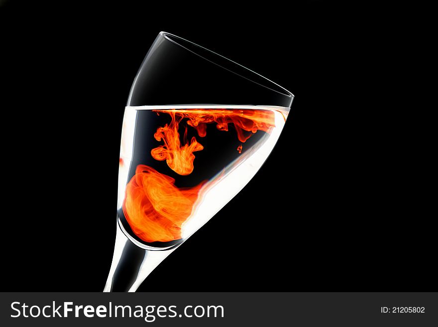 Negative image of wine glass with a splash of food colouring set against a white background. Negative image of wine glass with a splash of food colouring set against a white background