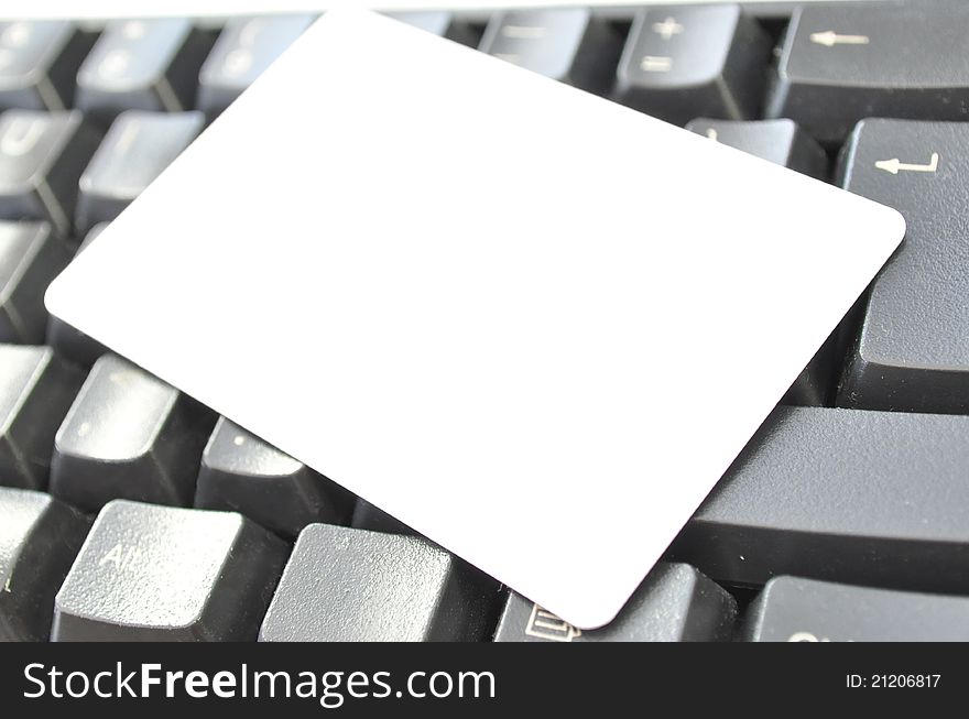 Blank contact card on a computer keyboard. Blank contact card on a computer keyboard