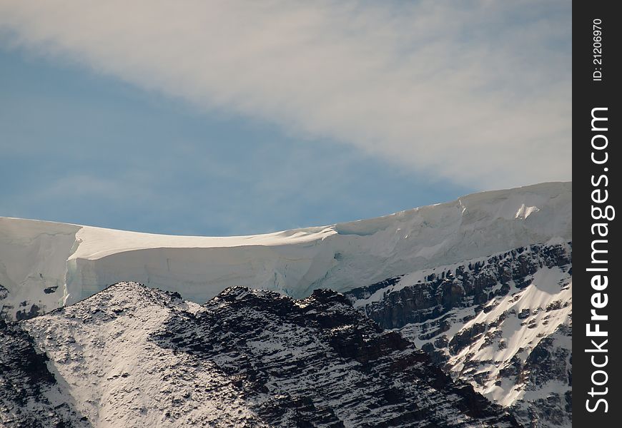 Giant snow drift on the top of a mountain. Giant snow drift on the top of a mountain