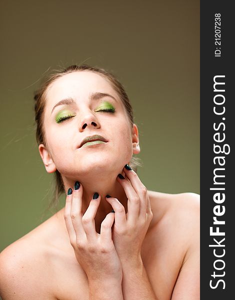 Ecology concept 
beautiful woman with luxury makeup green manicure, lips and cockade