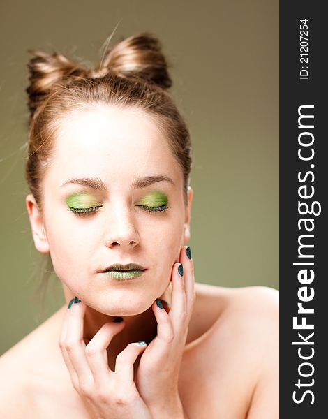 Ecology concept beautiful woman with luxury makeup green manicure, lips and cockade. Ecology concept beautiful woman with luxury makeup green manicure, lips and cockade