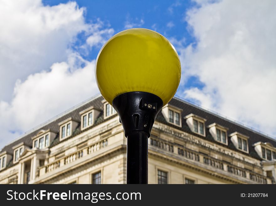 Yellow lamppost with blue sky in the background