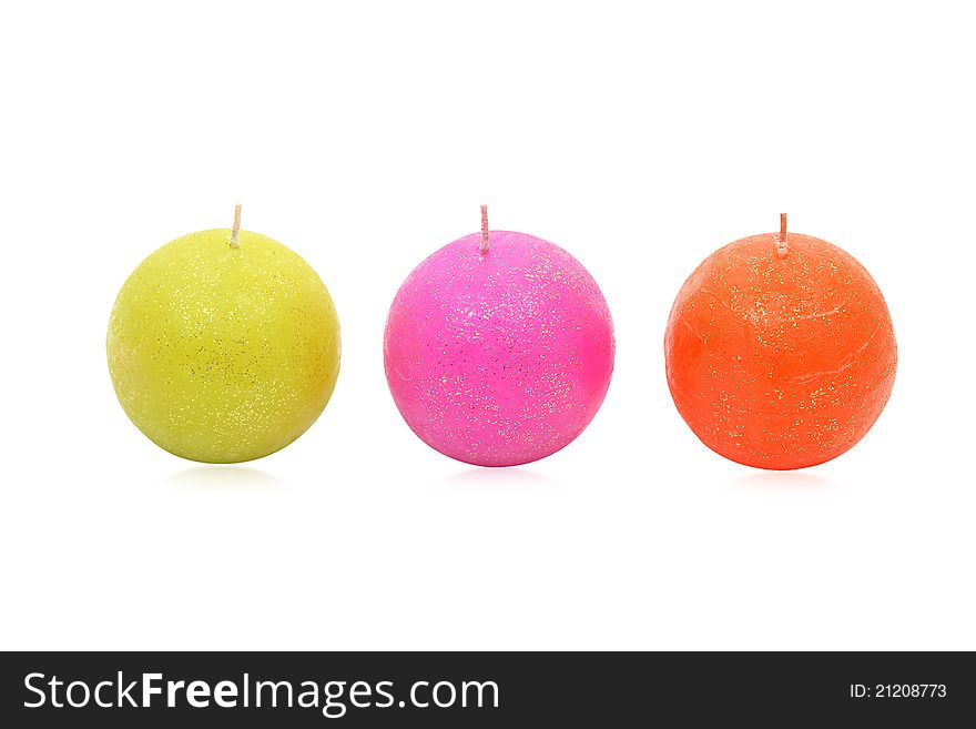 Image of three round coloured candles decorated with shiny speckles, isolated on a white background. Clipping path included. Image of three round coloured candles decorated with shiny speckles, isolated on a white background. Clipping path included.